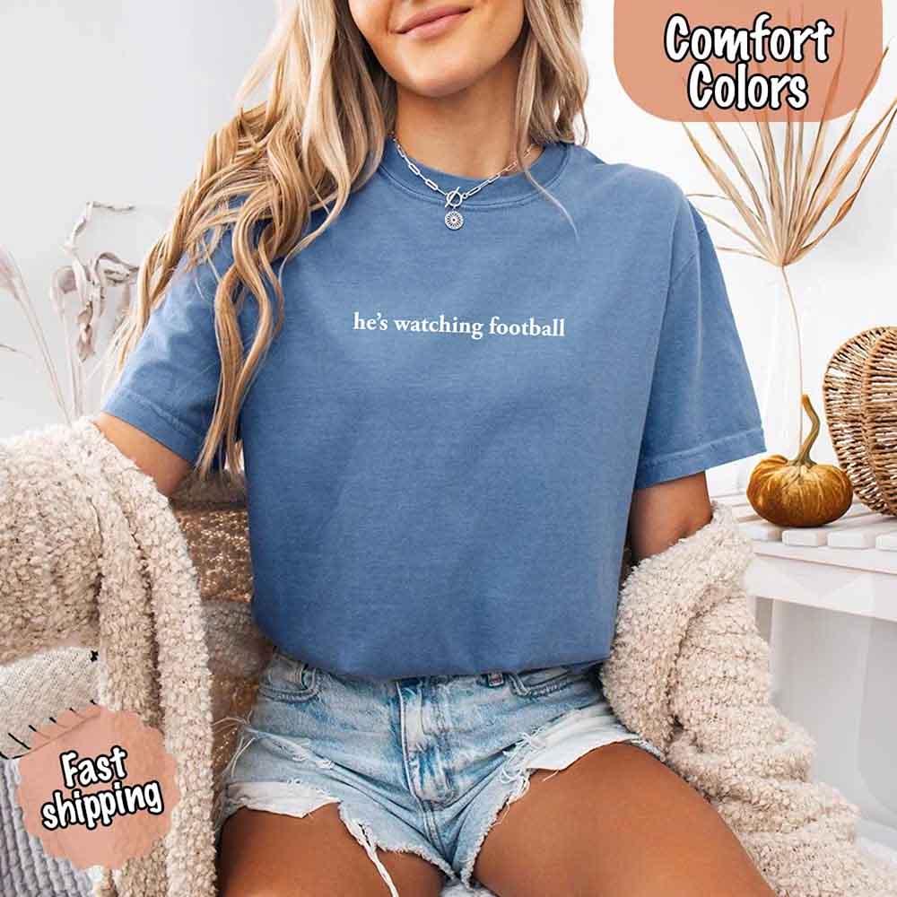 He’s Watching Football Tee - Comfort Colors Funny Shirt for Her