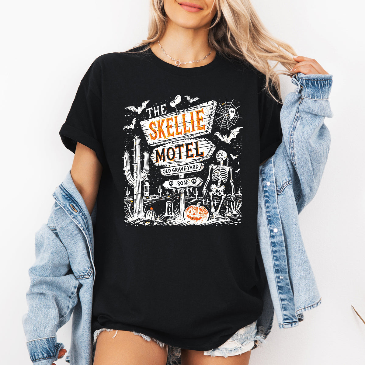 The Skellie Motel Graphic Tee Featuring Skeleton Halloween Artwork Perfect For Spooky Season